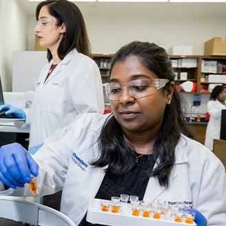 two clinicians examining tubes
